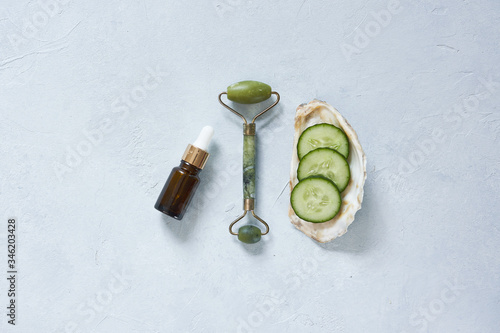 Fototapeta Naklejka Na Ścianę i Meble -  Natural ingredients and accessories for diy cosmetics and home spa treatment. Face roller, cucumber and natural oil.