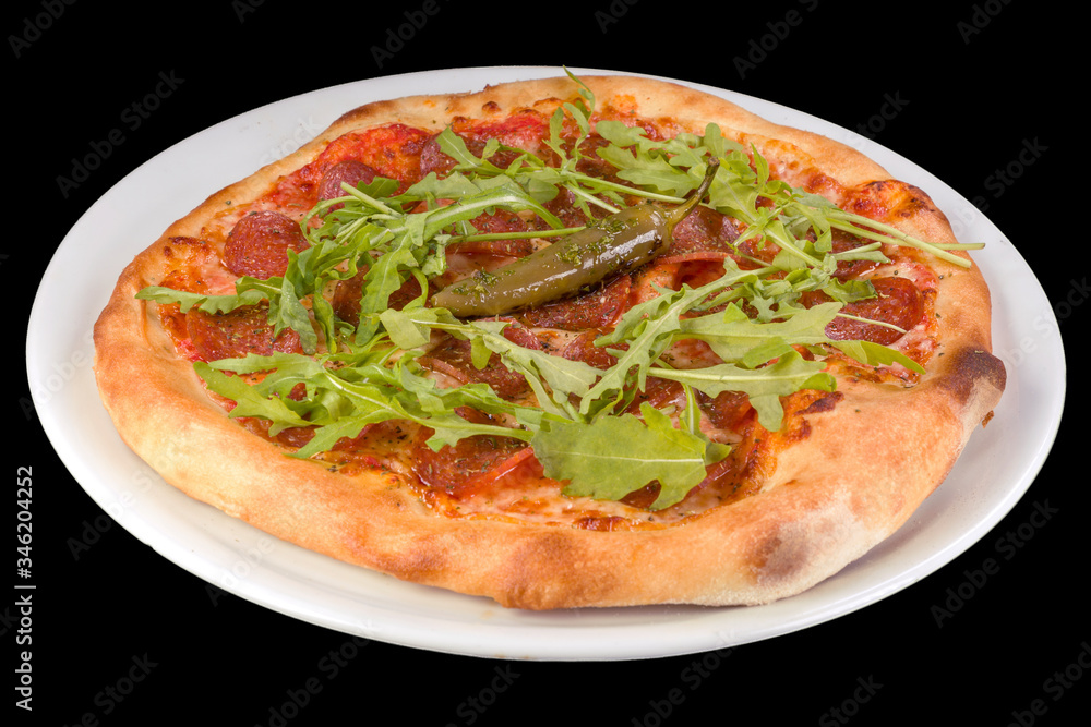 Tasty pizza pepperoni with tomato sauce, salami, arugula, hot pepper in a plate, isolated on black background. Tasty pizza pepperoni with tomato sauce, salami, arugula, hot pepper in a plate, isolated on black background.