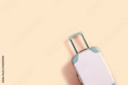 Pink suitcase for travel on a pink background. Summer dreams. Flat lay, copy space, isolated.