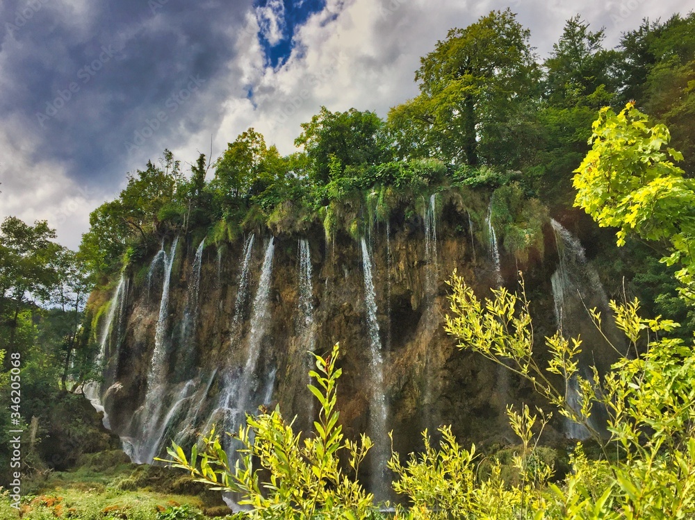 Waterfall at upper lakes in Plitvice lakes national park. Beautiful sunny day in Croatia. 