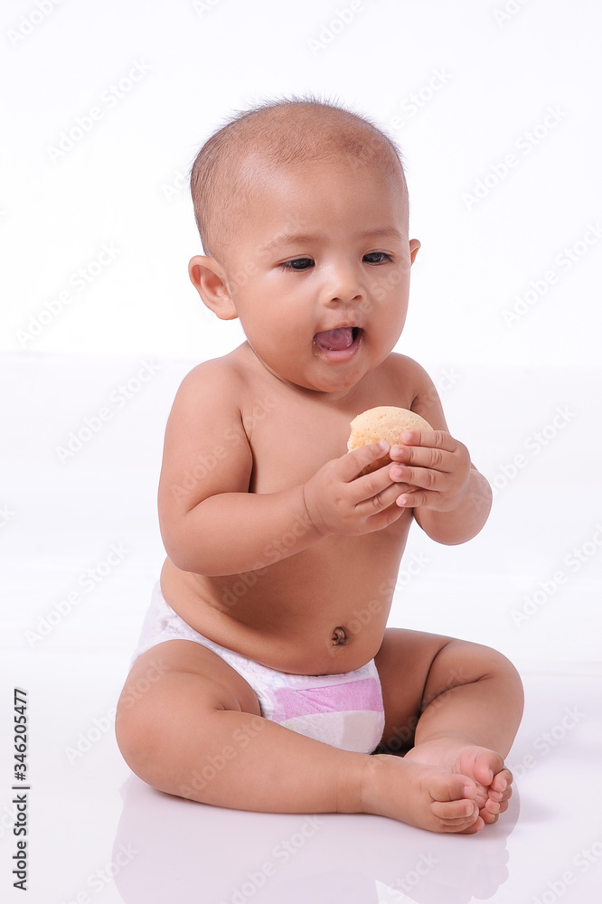 A Little Cute Asian Baby girl wearing diaper open her mouth ready eating biscuit A Little Cute Asian Baby girl wearing diaper open her mouth ready eating biscuit