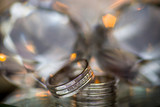 Close-up of two Wedding rings on a diamond shaped crystal or glass on a weddings day 