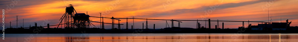 Silhouette of a sand factory at sunset. Silhouette of a sand factory at sunset.