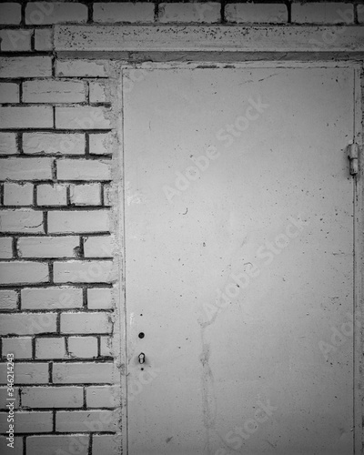 Isolated monochrome closeup dramatic old wall background built white bricks and gray concrete with old doors no handle