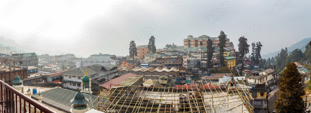 DARJEELING, WEST BENGAL, INDIA – FEB, 27 2013 : Panorama of Darjeeling city covered with fog.