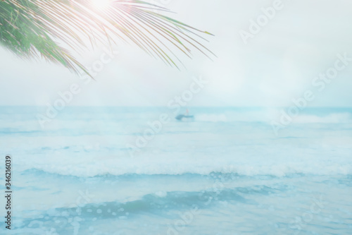 abstract blur summer background from blue sea and jet ski with coconut leaf on sunny day
