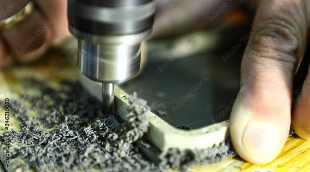 The master works with plastic using a drilling machine. Macro, shallow depth of field.
The master works with plastic using a drilling machine. Macro, shallow depth of field.
