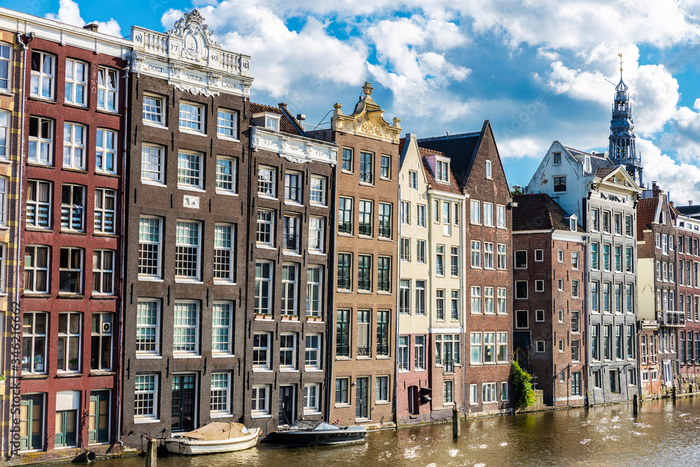 Old traditional leaning houses along the canal in Amsterdam, Netherlands