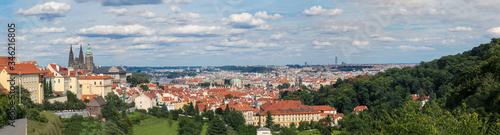 Panoramic view onto traditional red roofs in old town Prague and the river Vltava.