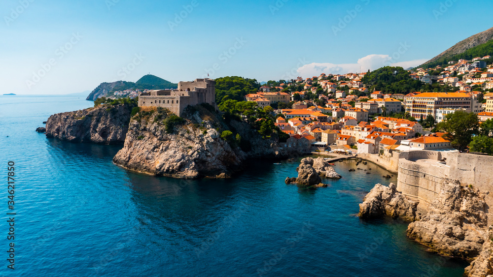 A bay in Croatia with a marina, castle and fort at the foot of the mountain
