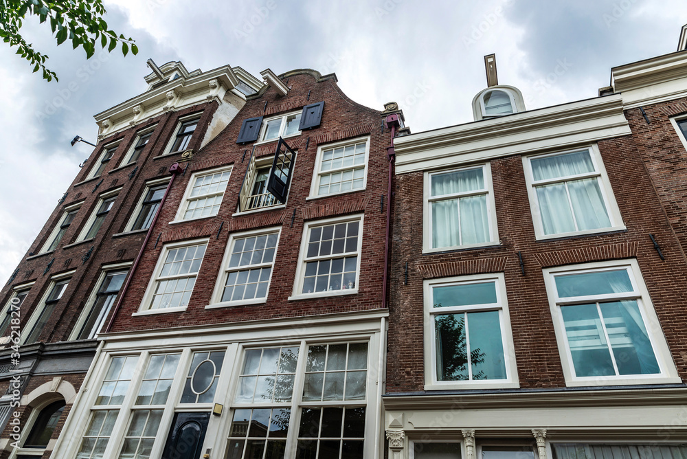 Fototapeta premium Old traditional leaning houses in Amsterdam, Netherlands