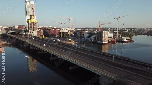 4K Helsinki Baltic Sea Finnish Bay lagoon early summer morning aerial video, Kalasatama upmarket neighborhood near Mustikkamaa Island over calm water channel in Finland capital Suomi northern Europe photo