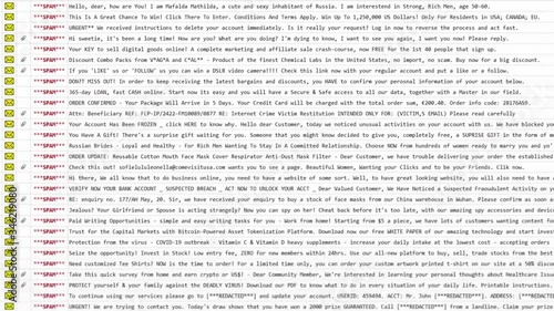 An email inbox, full of spam mail (unsolicited dangerous messages, often containing a virus as an attached file). Carefully looking at the many rows, slow mouse movements. photo