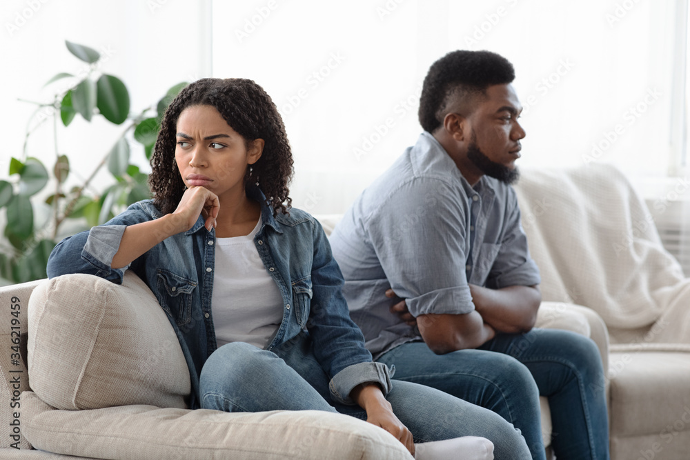 Young Family Problems. Pensive Man And Woman Sitting Upset After Quarrel Young Family Problems. Pensive Man And Woman Sitting Upset After Quarrel
