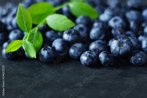  Blueberries on slate with blueberry leaf, macro blueberry   