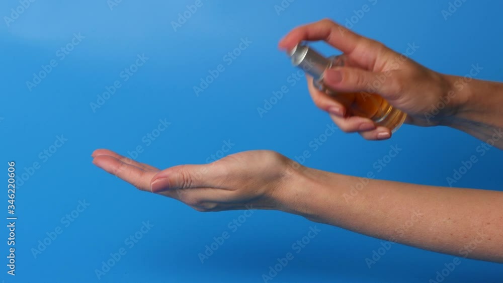 Hands of women that applying antibacterial spray to prevent spread of germs. Hands of women that applying antibacterial spray to prevent spread of germs.