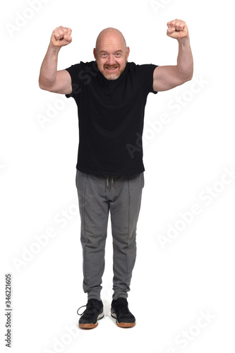 man with sportswear with fist raised on white background