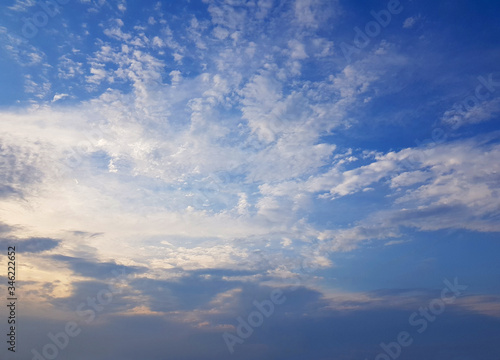 Blue sky clouds background. Beautiful landscape with clouds and orange sun on sky