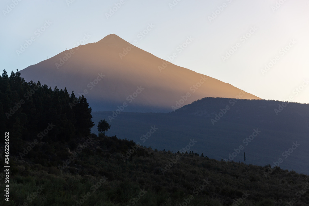 Majestic red Teide volcano is lit with the sunset in Tenerife, Canary Islands, Spain.