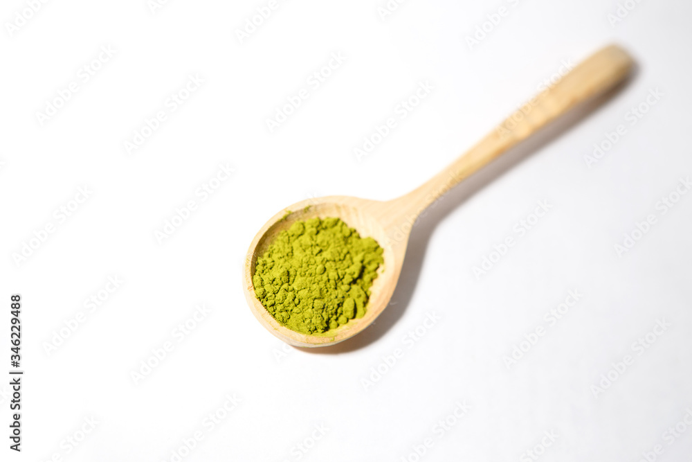 Green powder of Japanese matcha tea in a teaspoon. Matcha on a white background, isolated Green powder of Japanese matcha tea in a teaspoon. Matcha on a white background, isolated