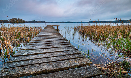 Fototapeta Naklejka Na Ścianę i Meble -  wooden pier on a lake in Mazury Region, Poland during early morning sunrise