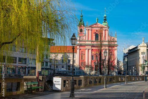 Beautiful church overlooks empty Prešeren Square and empty cobblestone streets. photo