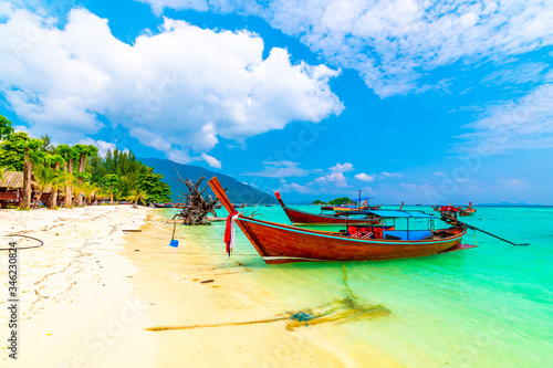 Long tail boat on the sea at Ko Lipe island, Thailand. Tropical island with white sand, beach and turquoise sea is part of Tarutao National Marine Park. Idyllic vacation, relaxation in paradise. © Martin