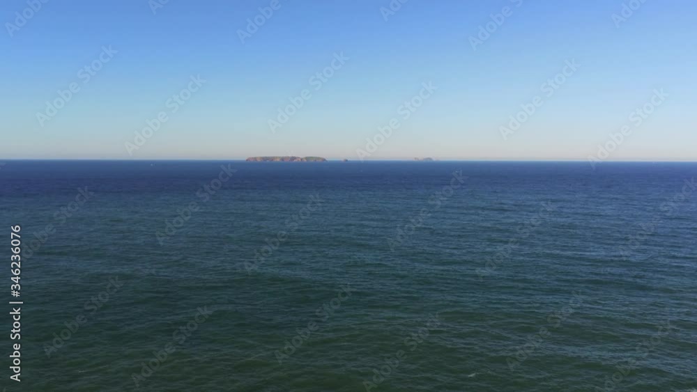 Aerial shot zooming out of a fortress island in the ocean on a sunny day Aerial shot zooming out of a fortress island in the ocean on a sunny day