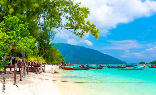 Tropical beach at Ko Lipe island  Thailand. Part of Tarutao national nature park. Beautiful beach  white sand  turquoise sea. Exotic vacation  tropical paradise. Trees and palms on beach.