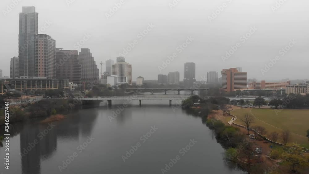 A drone flies over the glassy smooth water of the Colorado River in downtown Austin, Texas, on a misty morning. A drone flies over the glassy smooth water of the Colorado River in downtown Austin, Texas, on a misty morning.