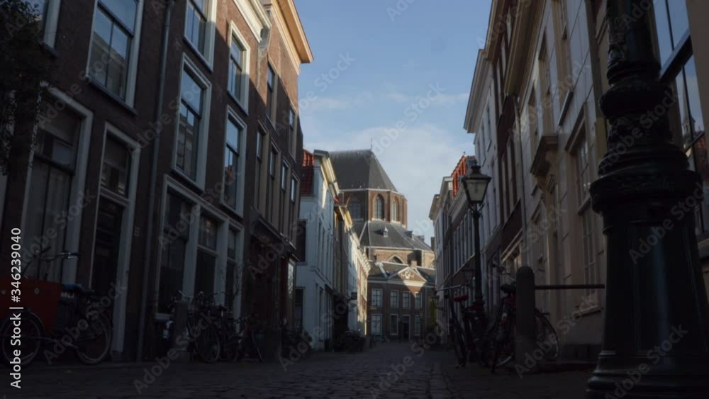 Slider shot of cobbled street and ancient church in historical city in the Netherlands Slider shot of cobbled street and ancient church in historical city in the Netherlands