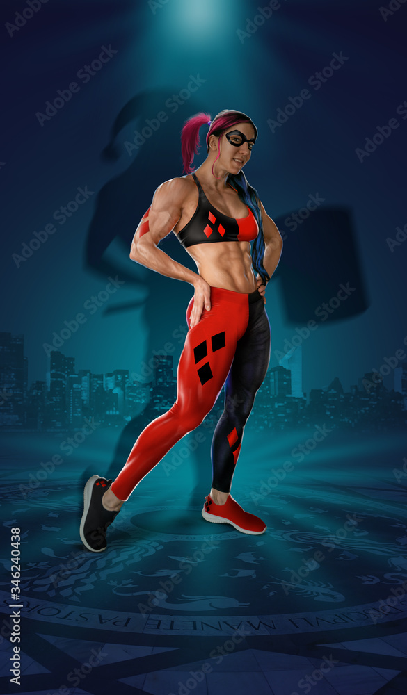 Beautiful superwoman concept dressed in red and black costume standing on fantasy stage