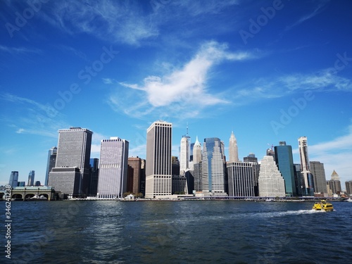 The Lower Manhattan skyline in New York City seen from the ocean on a sunny day