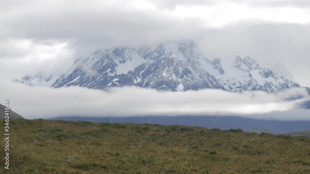 Beautiful view of the snowy mountains at Alberto Agostini National Park, Chile in a cloudy day.