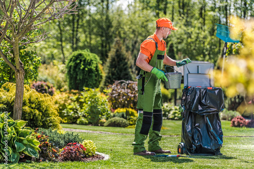 Gardener Cleans Private Yard Area After Routine Maintenance. photo