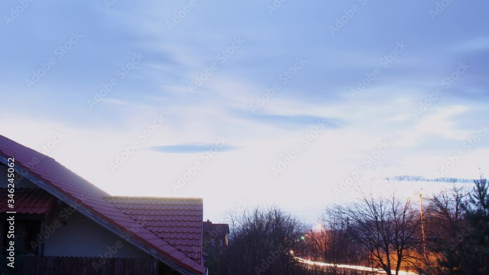 Sky View in the morning with a house with a lighted window left corner Sky View in the morning with a house with a lighted window left corner