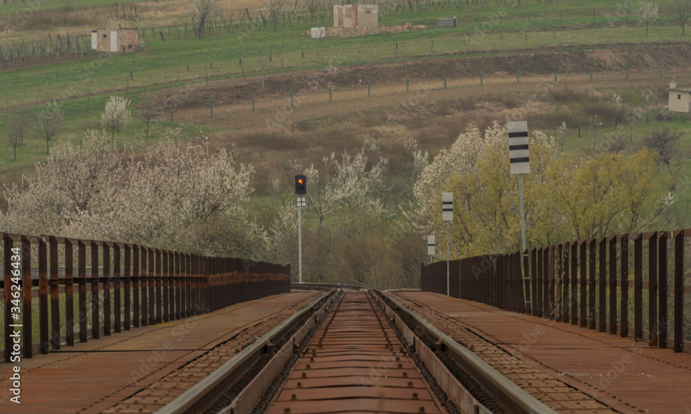 Railway bridge over Velicka river in spring cloudy day near Louka village