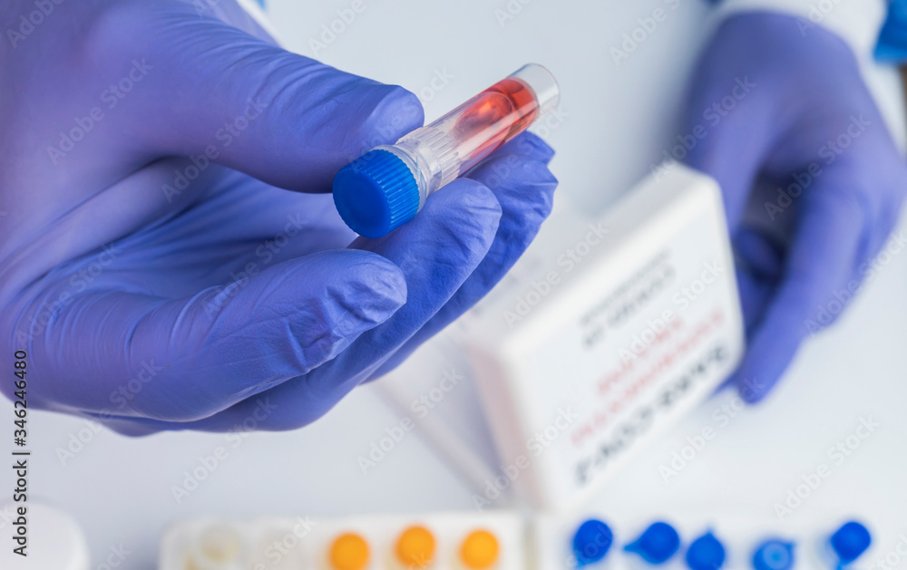 Scientist examines sample of coronavirus in laboratory, conceptual image Scientist examines sample of coronavirus in laboratory, conceptual image