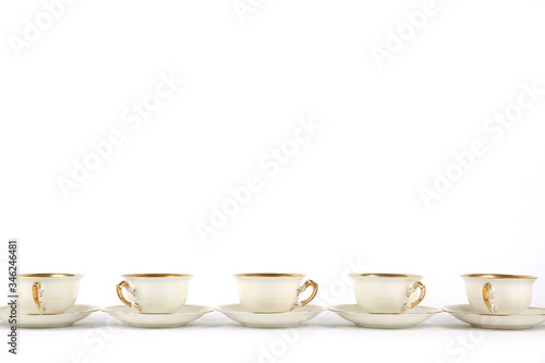 vintage porcelain cups on white background with copy space