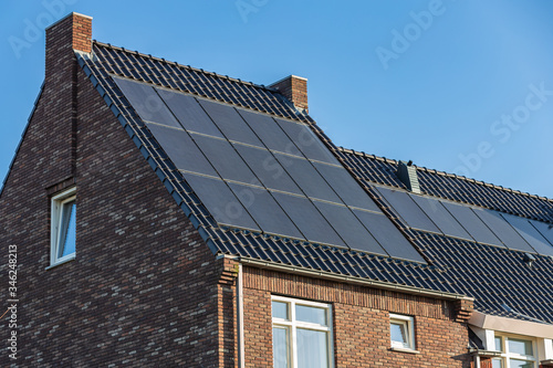 Solar panels on the roofs of houses on a sunny day 