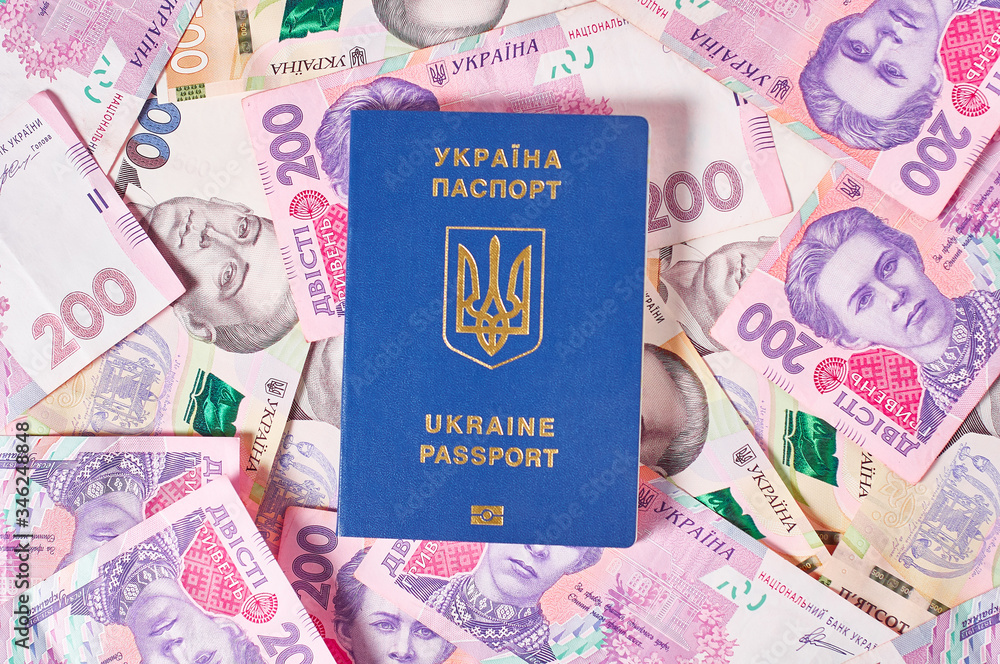 Passport of ukrainian citizen and banknotes. Concept of travel, donation or social payments