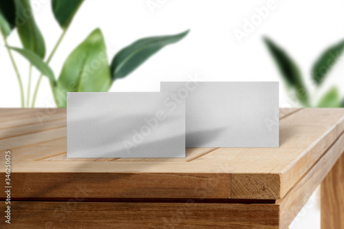 Clean minimal business card mockup on wood table