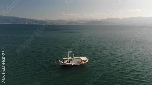Aerial view of a white fishing boat in the harbor of Stylida Greece photo