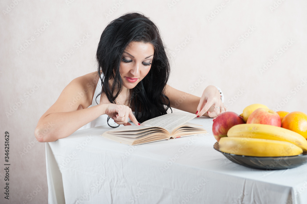 beautiful girl is reading a book. Portrait of a girl reading a book beautiful girl is reading a book. Portrait of a girl reading a book