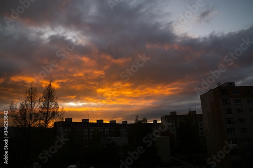 Sunrise and sunset, beautiful clouds over the meadow, hills and buildings in the town. Slovakia