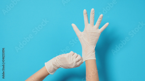 Two hand with white gloves and left hand is pulling.Put on blue background.