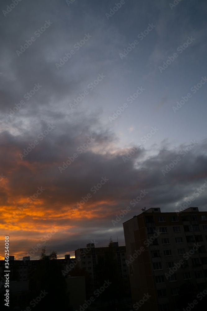 Sunrise and sunset, beautiful clouds over the meadow, hills and buildings in the town. Slovakia Sunrise and sunset, beautiful clouds over the meadow, hills and buildings in the town. Slovakia