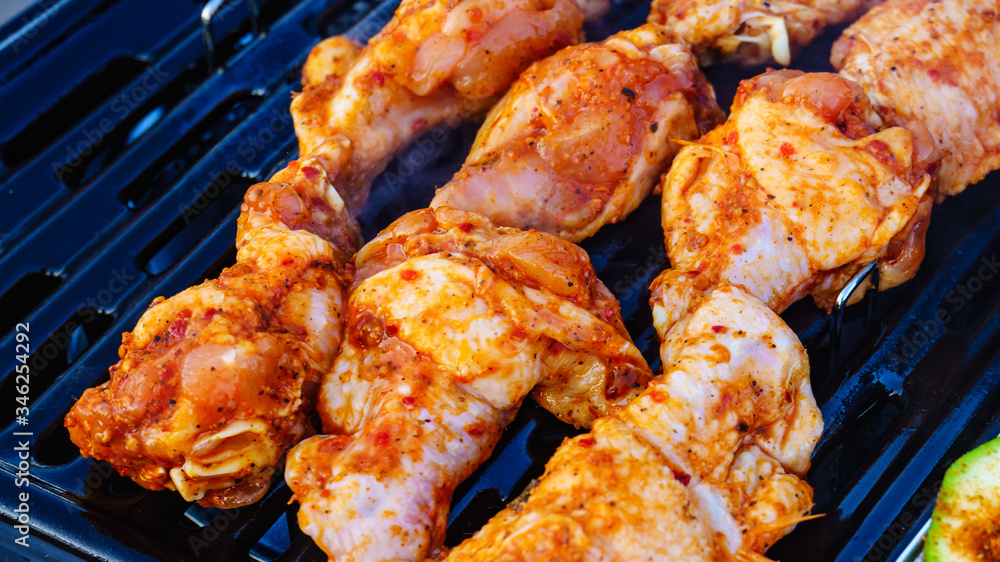 Chicken meat grilling on gas grill