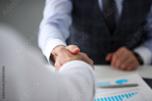 Man in suit and tie give hand as hello in office closeup © H_Ko