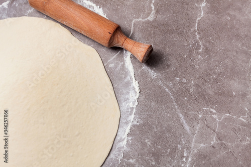 rolled dough with a rolling pin on a texture table photo